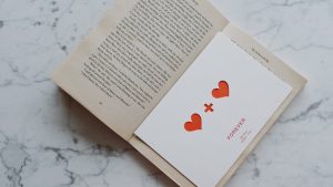 opened book with valentine lying inside